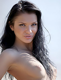 Smoking-hot raven-haired Siren Emma poses erotically in a green sundress.